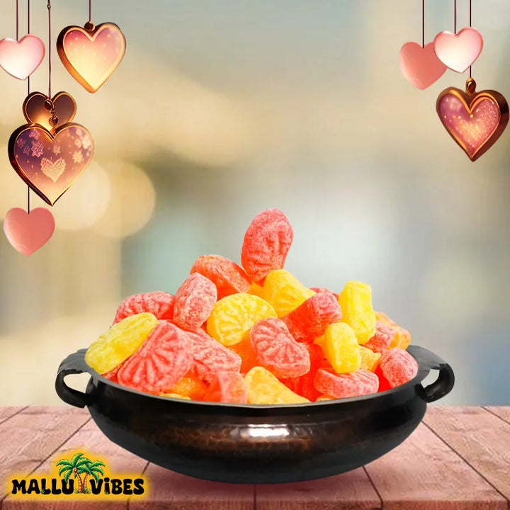 Front view of Traditional Kerala food Orange mittai in a bowl, english - Organic Kerala snacks Orange candy
