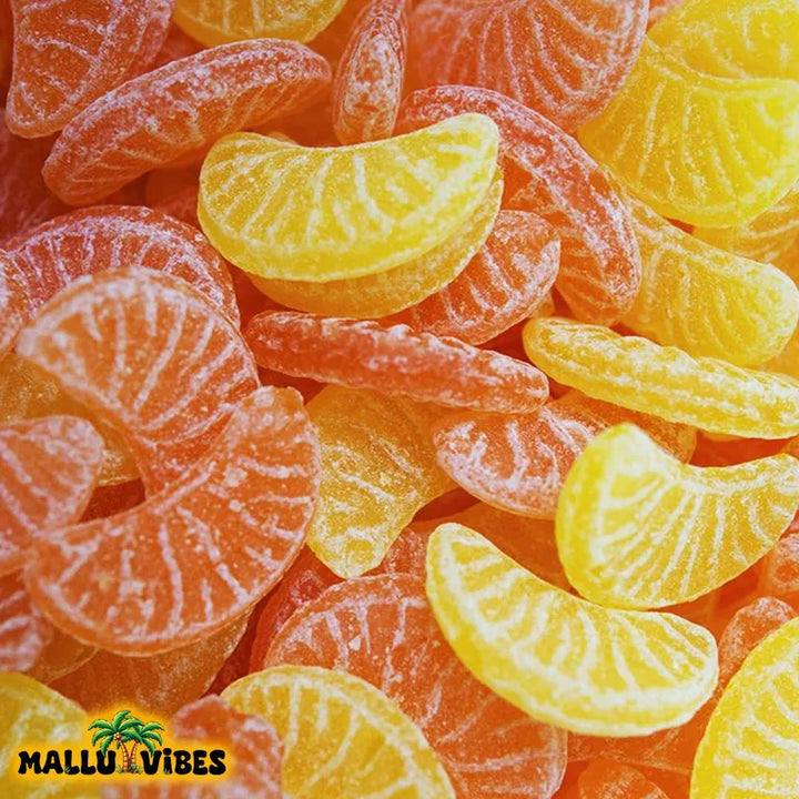 Top view of Traditional Kerala food Orange mittai in a bowl, english - Organic Kerala snacks Orange candy